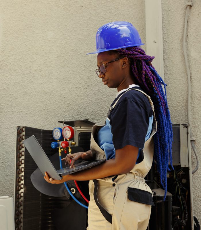 African american meticulous expert looking online for new air filters to replace outdoor air conditioner malfuntioning internal part during customer comissioned maintenance
